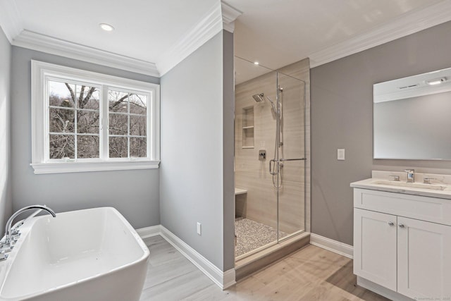 bathroom with hardwood / wood-style floors, vanity, crown molding, and independent shower and bath