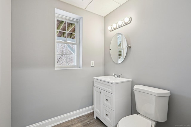 bathroom featuring toilet, vanity, and wood-type flooring