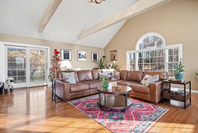 living room with hardwood / wood-style floors, beamed ceiling, and high vaulted ceiling