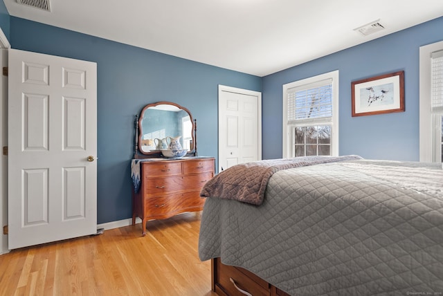 bedroom with a closet and light hardwood / wood-style flooring