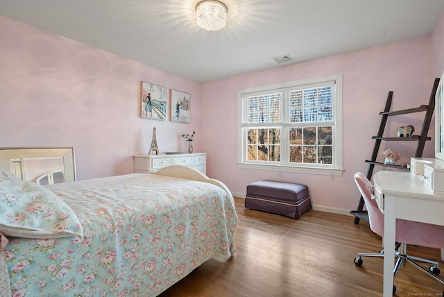 bedroom with hardwood / wood-style flooring