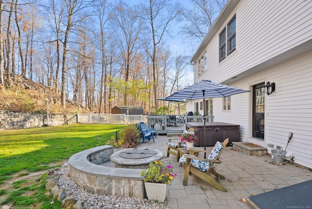 view of patio / terrace featuring a fire pit and a hot tub