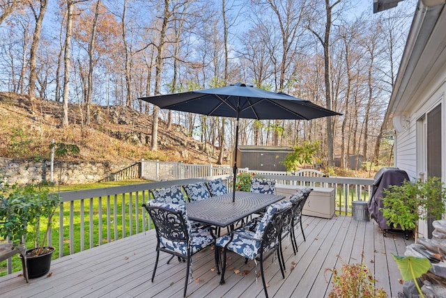 deck featuring a storage unit and grilling area