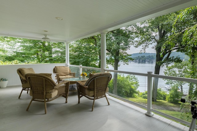 sunroom / solarium with a water view