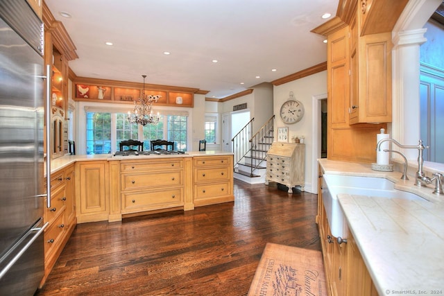 kitchen featuring appliances with stainless steel finishes, dark hardwood / wood-style flooring, crown molding, pendant lighting, and a chandelier