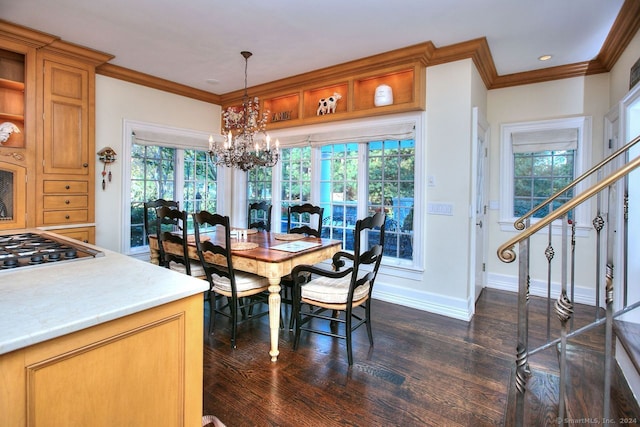 dining space with a wealth of natural light, an inviting chandelier, dark wood-type flooring, and ornamental molding