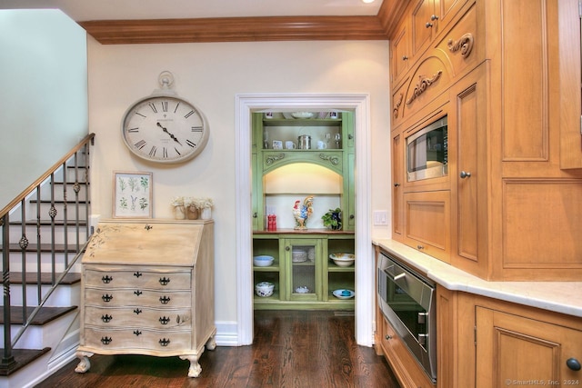 interior space with stainless steel microwave, wood-type flooring, and crown molding