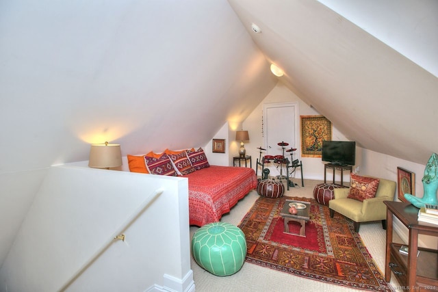 bedroom with carpet flooring and lofted ceiling