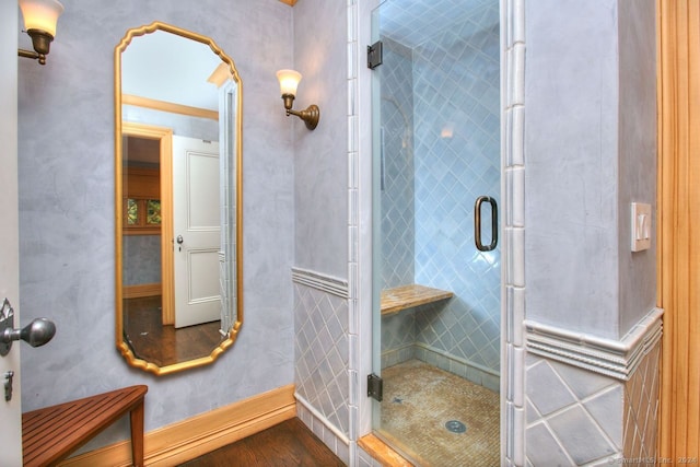 bathroom featuring hardwood / wood-style floors and an enclosed shower