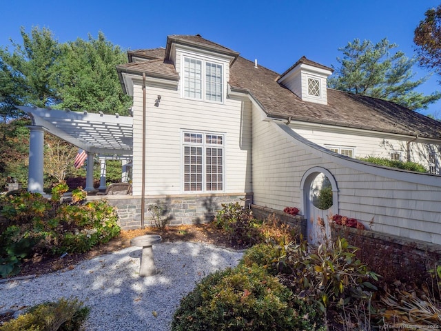 back of house featuring a pergola