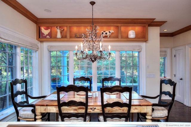 dining area featuring ornamental molding, dark wood-type flooring, and a chandelier