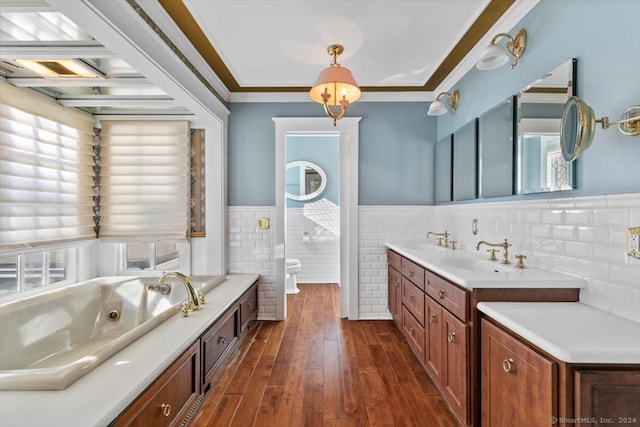 bathroom with toilet, tile walls, hardwood / wood-style floors, a bathing tub, and crown molding