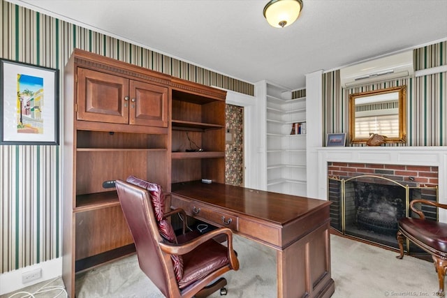 carpeted office space with a brick fireplace and a textured ceiling