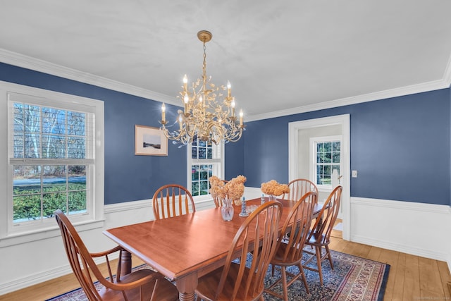 dining room featuring a chandelier, hardwood / wood-style floors, and ornamental molding