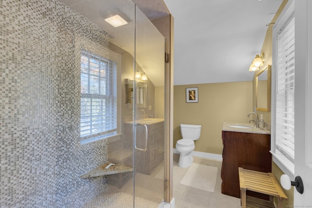 bathroom featuring a shower with door, vanity, vaulted ceiling, tile patterned flooring, and toilet