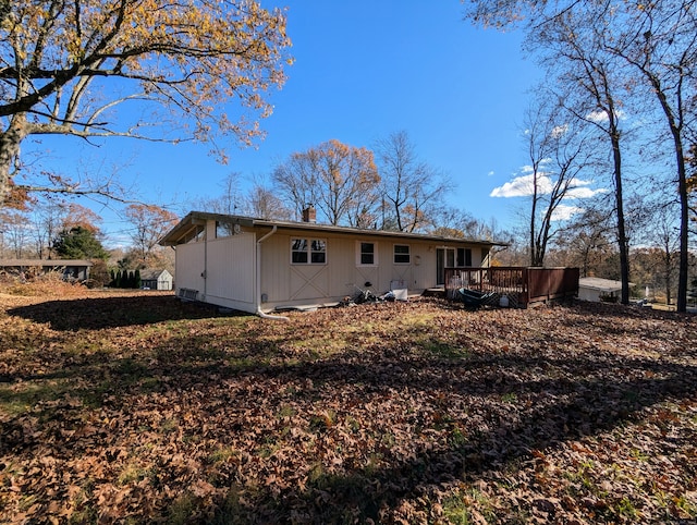 rear view of property with a wooden deck