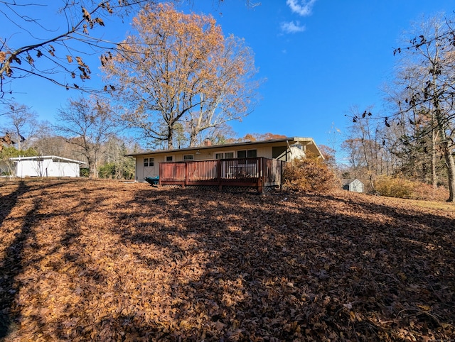 rear view of property featuring a deck