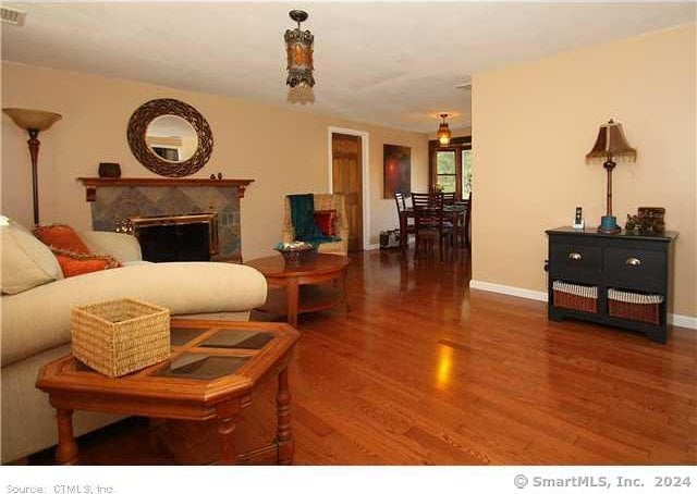 living room featuring hardwood / wood-style floors and a premium fireplace