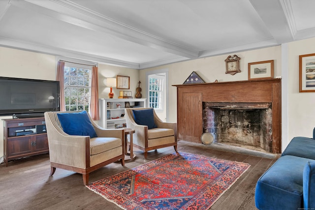 sitting room with beamed ceiling, dark hardwood / wood-style floors, and ornamental molding