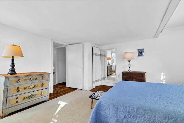 bedroom with dark hardwood / wood-style floors