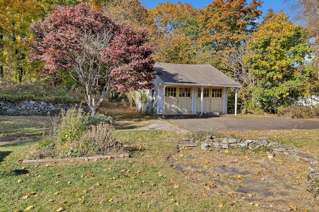 exterior space featuring a yard and an outbuilding