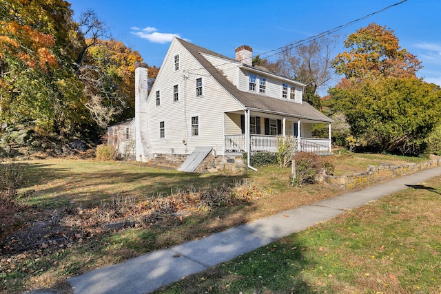 view of front of house with covered porch and a front yard