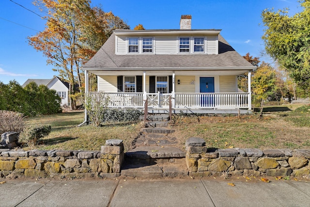 view of front of house with a porch and a front yard