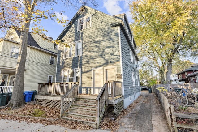 back of house with a wooden deck