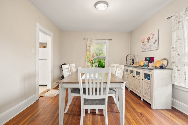 dining space with light hardwood / wood-style flooring