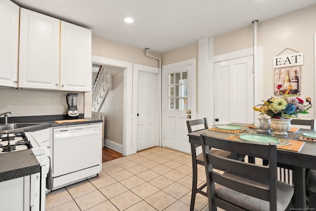 kitchen with white cabinetry, white appliances, sink, and light tile patterned flooring