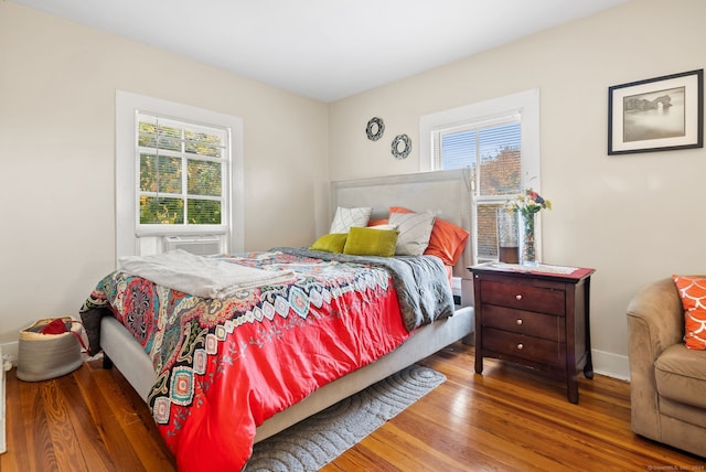 bedroom featuring hardwood / wood-style floors and cooling unit