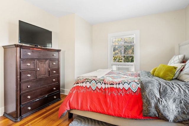 bedroom with hardwood / wood-style floors