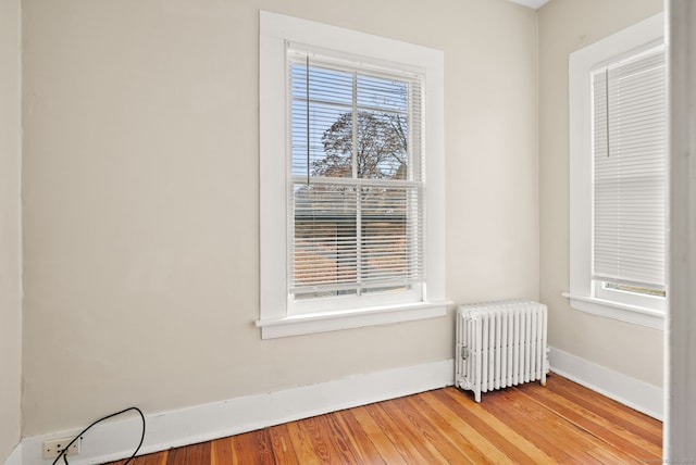 interior space featuring radiator and hardwood / wood-style flooring