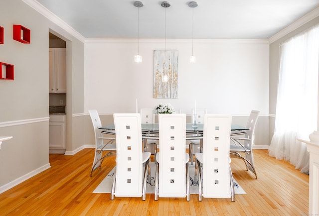 unfurnished dining area featuring ornamental molding, baseboards, and hardwood / wood-style flooring