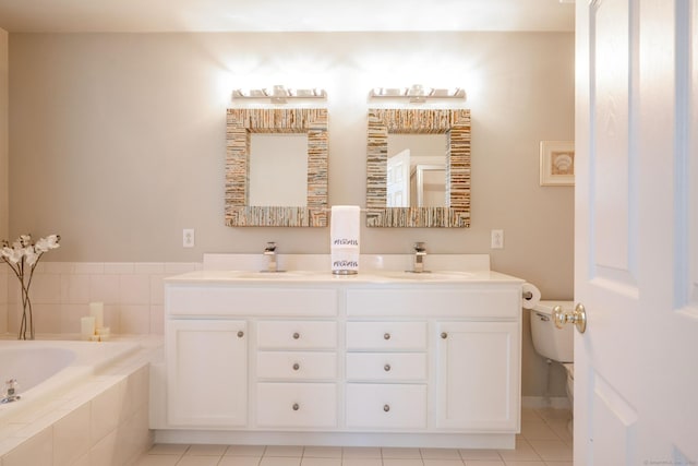 bathroom featuring a bath, tile patterned floors, double vanity, and a sink