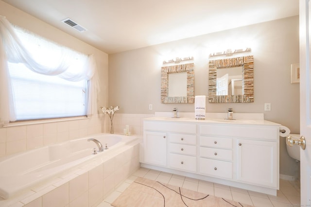 full bath with visible vents, tile patterned floors, double vanity, a bath, and a sink