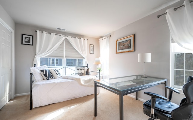 bedroom with multiple windows, baseboards, and carpet floors