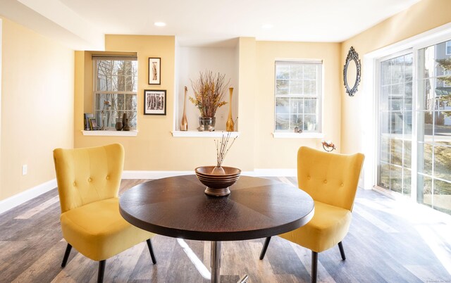 dining space featuring recessed lighting, wood finished floors, and baseboards