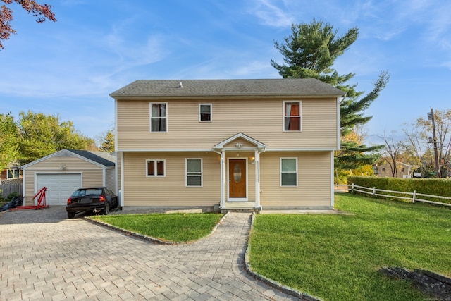 view of front of home with an outbuilding, a garage, and a front yard