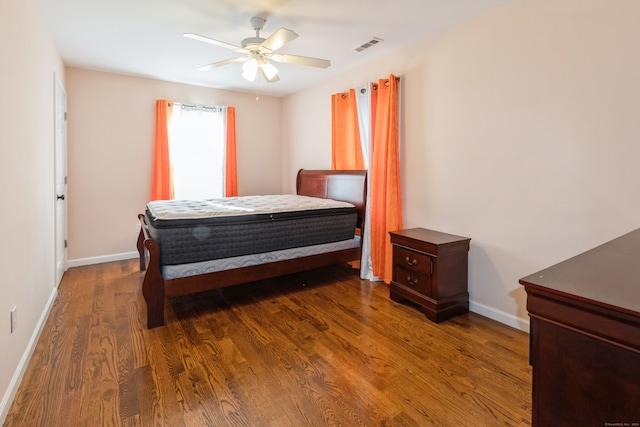 bedroom with dark wood-type flooring and ceiling fan