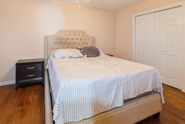 bedroom with dark wood-type flooring and a closet