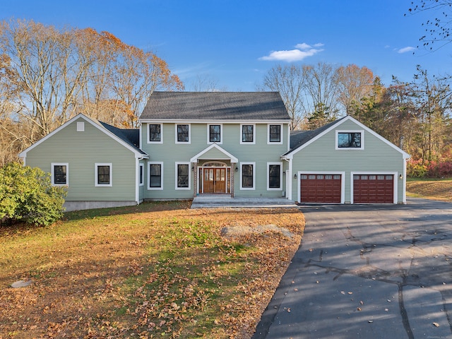 colonial inspired home featuring a garage