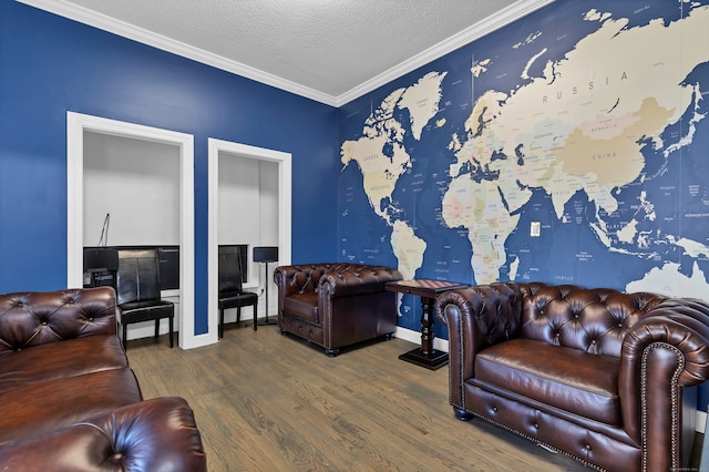 living room featuring wood-type flooring, ornamental molding, and a textured ceiling