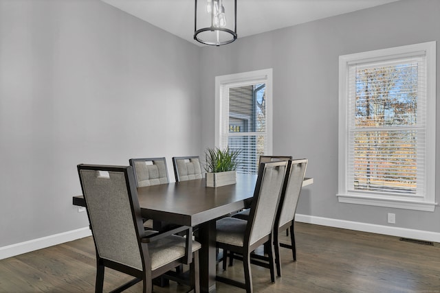 dining area featuring dark wood-type flooring and a wealth of natural light