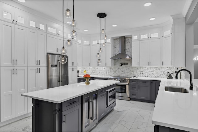 kitchen featuring white cabinets, stainless steel appliances, wall chimney exhaust hood, and sink