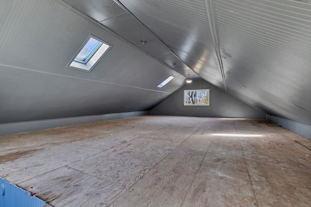 bonus room with lofted ceiling with skylight