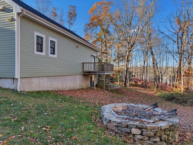 exterior space featuring an outdoor fire pit and a deck