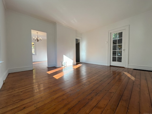 unfurnished room with a notable chandelier, dark hardwood / wood-style flooring, and crown molding