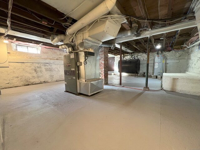 basement with electric water heater and heating unit