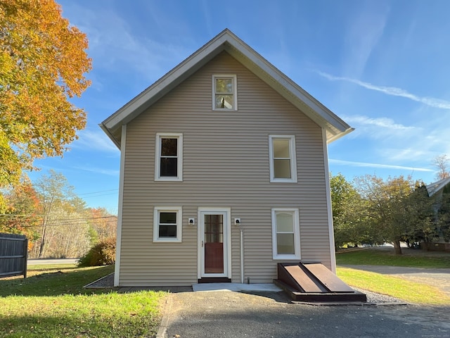 back of property with a lawn